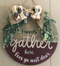 a sign that says friends gather here, yes go next door with two bows on it