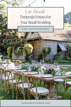 an outdoor table set up for a wedding with white flowers and greenery on it