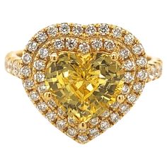 Elegant heart shape yellow sapphire ring. Hi brilliance, transparent clean, golden yellow tone, heart shape, unheated yellow sapphire mounted in high profile with five bead prongs, accented with two rows of round brilliant cut diamonds. Handcrafted heart shape classic design set in 14 karats yellow gold. Ideal for weddings and engagements! Yellow Sapphire: 3.19 carats, unheated, hi brilliance, golden yellow tone Diamond: 0.70 carat, round brilliant cut Color: G-H Clarity: Dimensions: 14mm x 14mm Yellow Heart Cut Fine Jewelry, Luxury Yellow Pear-shaped Ring, Heart-shaped Yellow Jewelry For Weddings, Heart Shaped Yellow Jewelry For Wedding, Gia Certified Heart Shaped Fine Jewelry Ring, Gia Certified Heart Diamond Rings, Heart Shaped Yellow Gold Jewelry With Center Stone, Heart-shaped Yellow Gold Jewelry With Center Stone, Yellow Diamond Pear-shaped Ring