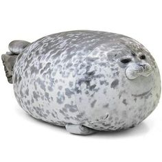 a stuffed seal animal sitting on top of a white floor