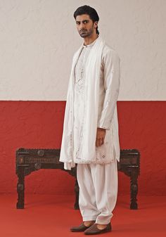 Elevate your style with White Embroidered mirror Kurta. Crafted from georgette, the classic white kurta features intricate hand embroidery and real mirror work, adding a touch of sophistication. Completed with a same-color embroidered dupatta and matching pants. Perfect for Sangeet, Mehendi, Haldi, or as a wedding guest outfit. Composition : Kurta, Patiyala & Dupatta : Viscose Georgette Care: Dry Clean Only and Vacuum Storage This product can be customized for sleeves, length and colour Delivery