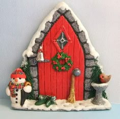 a christmas scene with a red door and snowman