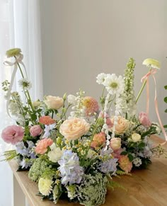 a wooden table topped with lots of flowers