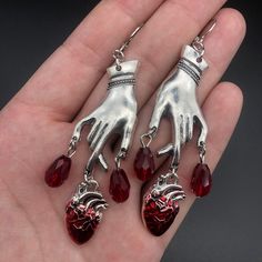 Drench your ears with these sultry Bleeding Heart Earrings with Red Blood Drops! Make a statement with these romantic gothic earrings, and let everyone know you have a heart of darkness. 'Tis a (blood) thirsty accessory to add to your wardrobe! Metals Type: Zinc alloy Vampire Ghost, Witchcraft Jewelry, Dripping Blood, Ghoulia Yelps, Red Gothic, Blood Drop, Just Aesthetic, Bottle Earrings, Carved Heart