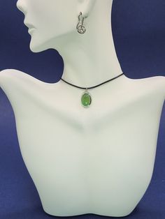 A silver pendant with chrysoprase on a black cord is not just a decoration; This is a powerful talisman that carries the power to energetically protect its owner. Chrysoprase, with its vibrant green hue, is more than just a stunning look. This gemstone is known for its healing properties, which are known to induce feelings of grace and balance. Set in silver, a metal with cleansing properties, it enhances the protective energy of the stone. Wearing this pendant creates a subtle shield around you Jade Cabochon Oval Pendant Necklace, Jade Cabochon Round Pendant Necklace, Jade Cabochon Pendant Necklace, Spiritual Green Oval Pendant Necklace, Green Oval Pendant Necklace Spiritual Style, Jade Oval Pendant With Natural Stones, Green Oval Pendant Necklace For Spiritual Style, Round Jade Cabochon Pendant Necklace, Nickel-free Jade Pendant Necklace