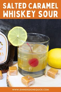 an image of a bottle of whiskey with lemons and cubes on the side