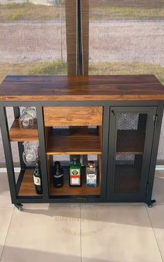 an entertainment center made out of metal and wood with shelves on each side that hold liquor bottles