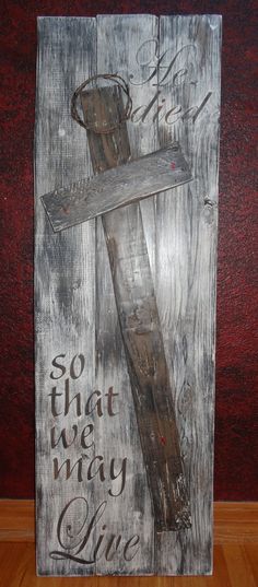 a wooden sign that says, so that we may live with the cross on it