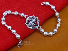 This amazing silver Rakhi crafted from 925 silver with immense precision. It exudes excellent craftsmanship and will surely look wonderful on your brother's wrist. handmade lord Ganesha Bracelet Or Rakhi bracelet this is special design beaded bracelet we can use either Rakhi bracelet or daily use bracelet for unisex. Best Rakshabandhan wishes sibling gift for your brother and sister's. Metal-925 sterling silver. Item type-Rakhi Bracelet. Length-6 inches.to 9 inches (select you size from option ) Traditional Bracelets With Sterling Silver Clasp As A Gift, Traditional Bracelets With Sterling Silver Clasp For Gift, Traditional Sterling Silver Clasp Bracelet For Gift, Symbolic Sterling Silver Bracelets For Festivals, Symbolic Bracelet Jewelry For Puja, Spiritual Silver Bracelet With Oxidized Finish, Spiritual Oxidized Silver Bracelets, Silver Bracelets With Oxidized Finish In Temple Jewelry Style, Silver Bracelet With Oxidized Finish For Festivals