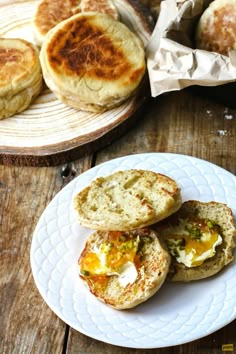 there are some breads on the plate with eggs and cheese in between them for breakfast