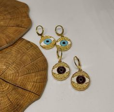 hoop earringsgold hoop earringsdangle earringshuggie hoop earringsclip on earringsgold evil eyeevil eye earringsgold earringsdrop earringsgift for hervintage earringsstatement earringseye earringsGold evil eye hoop earringsThis cute earrings are made from steell and they are 24k gold plated and handpainted.You can choose between 4 different clasps (the numbers 1 and 2 are for non pierced ears)They are very light and comfortable!Plus they are anti allergic/ nickel free ❤Evil eye meaningThe evil e Gold Round Evil Eye Earrings, Gold Evil Eye Drop Earrings, Adjustable Gold Evil Eye Earrings, Trendy Handmade Gold Plated Jewelry, Yellow Gold Evil Eye Jewelry, Adjustable Teardrop Evil Eye Jewelry, Tarnish Resistant Adjustable Drop Earrings, Eye-catching Handmade Jewelry For Gifts, Evil Eye Round Earrings For Gift