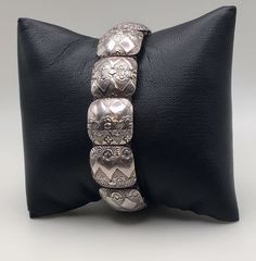 Introducing our exquisite Vintage Sterling Silver Carved Panels Leather Bracelet, a timeless piece that exudes elegance and charm. Good pre-own condition. Stamped "STERLING" mark inside of the bracelet. Bracelet Length: 7" (17.8 cm) Bracelet wide: 5/8" (1.6 cm) Weight: 38 grams (1.2 Troy Oz)  Please carefully review the item description and accompanying pictures before making a purchase, as we do not offer a return or exchange policy. If you have any questions or require assistance, please do not hesitate to reach out to us. Check my store link to find more treasures :   https://galaxysilvercity.etsy.com Luxury Sterling Silver Western Bracelets, Elegant Handmade Metal Stretch Bracelet, Elegant Adjustable Rectangular Beaded Bracelets, Classic Antique Silver Bracelets For Formal Occasions, Classic Antique Silver Bracelet For Formal Occasions, Classic Adjustable Bracelet With Intricate Design, Formal Adjustable Etched Cuff Bracelet, Elegant Etched Metal Bracelets, Ornate Adjustable Bracelets For Ceremonial Occasions