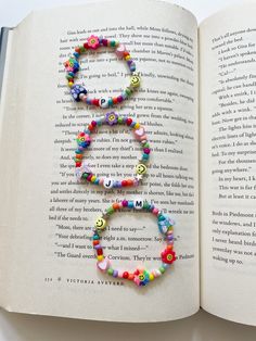 an open book with beads and letters on the pages that spell out'8 '