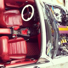 the interior of a white car with red leather seats