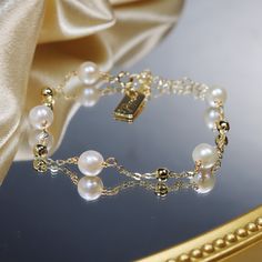 When it comes to the perfect gifts for your loved ones, look no further than this stunning Natural Freshwater Pearl Bracelet! Woven with care, this bracelet will add a touch of delicate luxury to any woman's wrist. Crafted with 14k gold plated metal, this bracelet features a minimalist temperament perfect for any occasion. A classic yet chic piece that brings just a hint of sparkle to any outfit, this pearl bracelet is sure to become her favorite jewelry staple! Whether she wears it casually or to an event, every girl will be sure to feel special. A timeless gift, this bracelet is great for any special occasion and can easily be added to any holiday wishlist. Bring a gentle shimmer to any ensemble with this beautiful and understated Natural Freshwater Pearl Bracelet! This effortless bracel Handmade Elegant Gold-plated Beaded Bracelets, Feminine Pearl Bracelet For Gift, Feminine Pearl Bracelet Gift, Handmade Gold-plated Elegant Beaded Bracelet, Gold Bracelet With Pearl Charm, 14k Gold Filled, Elegant Handmade Gold-plated Beaded Bracelets, Elegant Pearl Rosary Bracelet With Pearl Charm, Elegant Pearl Rosary Bracelet With Round Beads, Elegant Handmade Gold-plated Beaded Bracelet