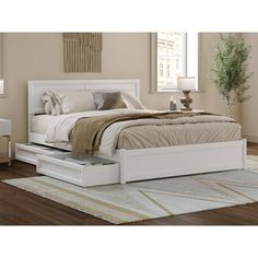 a white bed sitting on top of a wooden floor