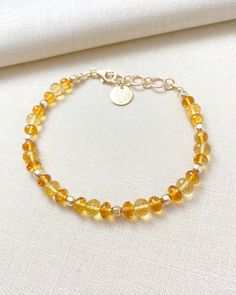 The enchanting combination of sunny yellow and rich amber-hued citrine creates this beautiful gemstone bracelet. This elegant beaded piece is finished with luminous 14k gold-filled components. November's birthstone is nothing less than captivating. Bracelet length: 7.25 inches plus 1-inch extender Materials: 4-6 mm citrine faceted beads, 14 k gold-filled components Citrine Bracelet, Sunny Yellow, Gemstone Beaded Bracelets, November Birthstone, Citrine Gemstone, Faceted Bead, Gemstone Bracelet, Beaded Bracelet, Citrine