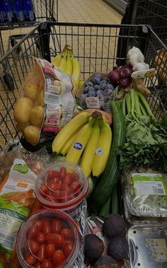 a shopping cart filled with lots of fruits and vegetables