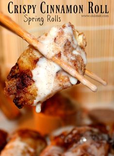 a close up of food on a stick with the words crispy cinnamon roll spring rolls