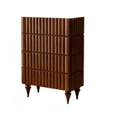 a tall wooden cabinet with four legs and an interesting pattern on the front, against a white background