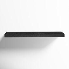 a black shelf is shown against a white wall