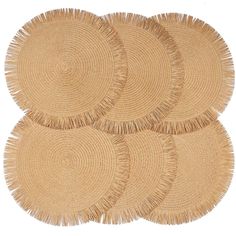 four round straw placemats with fringe edges