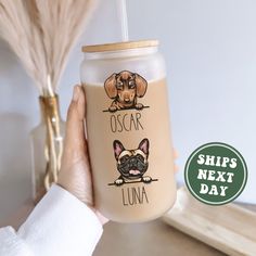 a person holding a cup with a dog on it