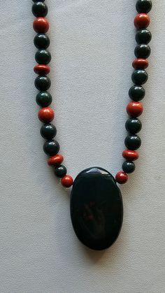 This necklace is Bloodstone beads with Red Jasper round and oval beads spaced intermittently,  along with a Bloodstone oval pendant. Bloodstone dispels negative influences from the auricular field, while balancing and grounding the body.I pair Bloodstone w/ Red Jasper which works similarly, offering physical strength , vitality and stability. Red Jasper Necklace, Bloodstone Necklace, Frog Necklace, Physical Strength, Quartz Crystal Pendant, Jasper Necklace, Oval Beads, Garnet Pendant, Jasper Beads