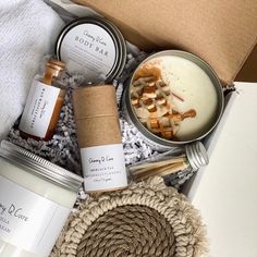 an open box containing various items such as candles, soaps and body scrubs