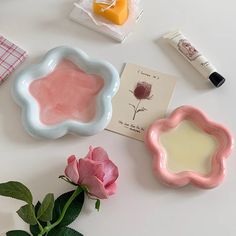 some pink flowers and other items on a table