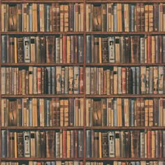 a book shelf filled with lots of books on top of it's sides in front of a wall