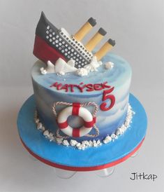 a birthday cake with a cruise ship and life preserver on it's side