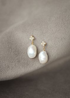 Clover are a set of pearl drop earrings that are a tribute to timeless beauty. These exquisite earrings are designed to add a touch of sophistication and grace to your bridal ensemble, enhancing your natural beauty without overpowering your overall look. * DETAILS * > Freshwater pearls, gold or antique silver plated findings > Dimensions: 25mm length (11-12mm pearl) * READY TO SHIP * The Clover earrings are ready to ship. Please allow 5-7 business days for processing plus delivery times. Please Luxury Pearl Embellished Earrings For Wedding, Luxury Wedding Pearl Earrings With Pendant, Luxury Pearl Pendant Earrings For Wedding, Anniversary Bridal Earrings With Pearl Drop In Yellow Gold, Anniversary Yellow Gold Bridal Earrings With Pearl Drop, Anniversary Bridal Earrings In Yellow Gold With Pearl Drop, Luxury Pearl Charm Bridal Earrings For Wedding, Timeless Drop Earrings For Bridal, Luxury Bridal Earrings With Pearl Charm For Wedding