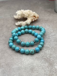 Step into a world of serene beauty with our Elegant Turquoise Stretch Bracelet. This exquisite piece is carefully handcrafted, featuring genuine turquoise beads in a mesmerizing shade of blue that evokes the tranquility of the sea and the vastness of the sky. Each bead is a testament to the timeless allure of turquoise, a stone cherished through centuries for its unique hue and spiritual significance. Turquoise 8mm Sterling Silver spacers Turquoise Howlite Beaded Bracelets, Turquoise Beaded Howlite Bracelets, Turquoise Amazonite Round Bead Bracelets, Turquoise Beaded Bracelet For Meditation, Turquoise Natural Stone Bracelets, Turquoise Howlite Bracelets With Natural Stones, Turquoise Gemstone Beads Bracelet As Gift, Turquoise Amazonite Beaded Bracelets With Gemstone Beads, Turquoise Gemstone Beads Bracelets For Gifts