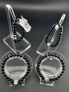 - This striking accessory features high-quality Black Onyx beads, exuding a rich, deep black hue that evokes a sense of power, sophistication, and confidence. - As a powerful grounding stone, it promotes emotional stability, mental clarity, and focus, while protecting negative energies and psychic attacks. - Black Onyx is also believed to enhance inner strength, resilience, and self-discipline, empowering you to face life's challenges with courage and grace. - Embrace the potent energy and capti Elegant Onyx Beaded Bracelets With Black Beads, Black Bracelet Jewelry For Parties, Black Bracelet For Party, Black Round Beads Bracelets For Party, Black Party Bracelet Jewelry, Black Onyx Jewelry With Black Beads, Elegant Black Onyx Bracelets, Black Crystal Bracelet With Round Beads For Party, 8mm Beaded Bracelet For Parties