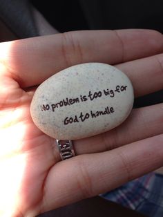 a person holding a rock with the words no problem is to try god's handle