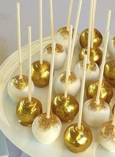 white and gold cake pops on a plate