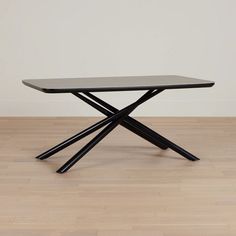 a black table sitting on top of a hard wood floor