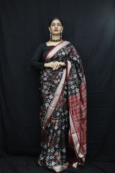 Exclusive hand-woven Sambalpuri silk saree with Pasapali Finest pure handwoven sambalpuri ikat silk saree with traditional motifs woven by the master weavers of Sambalpur, Odisha. It has lovely patterns and is world-famous for its stunning colours, texture and designs. Occasion: Party Wear Fabric: Sambalpuri Primary Color: Black Secondary Color: White Material: Mulberry Silk/ Sambalpuri Silk Pattern: Motif Border Type: Ikkat Border Size: Medium Blouse Piece: Included Care: Dry Clean Disclaimer : This is a genuine handwoven piece, unevenness in the selvedge and weave could be expected and colours may fade or bleed due to the traditional dyeing method employed. Sambalpuri Blouse Design, Chanderi Dupatta With Ikat Print For Festivals, Chanderi Ikat Print Dupatta For Diwali, Chanderi Ikat Print Dupatta In Traditional Drape, Chanderi Dupatta With Ikat Print In Traditional Drape, Festive Chanderi Dupatta With Ikat Print, Festive Ikat Print Dupatta In Traditional Drape, Diwali Ikat Print Chanderi Dupatta, Traditional Banarasi Silk Saree With Ikat Print