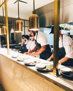 the chefs are preparing their meals in the large kitchen area for customers to come home