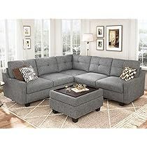 a living room with a sectional couch and ottoman