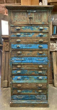 an old wooden dresser with blue paint on it