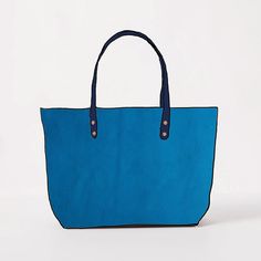 The Cerulean Cypress East West Tote is a large leather tote bag handmade in the USA with heirloom-quality craftsmanship and the very best materials. Cerulean Cypress is a thick and soft leather with a pillowy texture, even bright blue color, little to no pull-up, and pebbled grain. The Cerulean Cypress East West Tote comes standard with Navy handles. Chic Blue Shoulder Bag With Rolled Handles, Modern Blue Bags With Rolled Handles, Modern Blue Everyday Bags, Modern Blue Daily Bag, Modern Everyday Blue Bag, Modern Everyday Blue Bags, Modern Turquoise Bag For Everyday Use, Turquoise Bags With Leather Handles For Everyday Use, Modern Blue Bag With Leather Handles