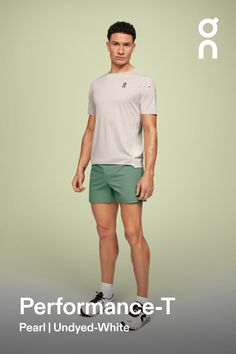 a man in green shorts and a white t - shirt