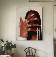 a woman's hand with pink nail polish holding up her nails in front of a mirror