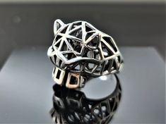 EXCLUSIVE DESIGN GEOMETRIC PANTHER RING PURE 925 STERLING SILVER RING This beautiful Panther Ring has been Fabulously casted with 925 Sterling Silver and has been designed with geometric shapes and patterns. The weight of the ring is 11-12 grams We have every size available, please inquire if you don't see your size available. We are a Los Angeles based company operating out of Thailand so that we may bring you the highest quality items at the most competitive prices, just search and compare, we Modern Geometric Sterling Silver Rings, Modern Sterling Silver Rings With Geometric Shape, Modern Sterling Silver Rings With Geometric Design, Geometric Sterling Silver Ring, Silver Geometric Sterling Silver Ring, Geometric Silver Ring As Gift, Silver Geometric Ring Gift, Sterling Silver Geometric Ring In Silver, Silver Geometric Ring As Gift