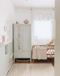 a baby's room with a crib, dresser and bed in the corner