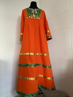 This is stunning vintage-style Afghan Dress is made from 100% cotton. The dress is suitable for all occasions. One size fits many as ,but it is most suited to medium body size. Dimensions: Shoulder: 39.5cm Length: 137cm Sleeve:51cm Waist size:98cm Cotton Handloom Dresses For Festivals, Cotton Maxi Dress For Traditional Ceremonies, Fitted Orange Cotton Dress, Festive Cotton Dress With Woven Motifs, Cotton Dresses For Traditional Ceremonies, Bohemian Handloom Dresses For Festive Occasions, Fitted Cotton Dress For Traditional Ceremonies, Cotton Anarkali Dress For Traditional Ceremonies, Bohemian Cotton Handloom Dress