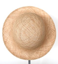 "\"Pina\" is a light summer sun hat with a wide flared brim. The shapely curve of the brim ensures a perfect fit and underlines a clear, feminine look. The material \"Bao\" made of the undyed fibres of the baobab tree is pleasantly permeable to air and ensures maximum wearing comfort. Available in sizes 55 cm - 60 cm. Colour \"nature\" Hat of \"Bao\" - Monkey bread tree Grosgrain ribbon (inside) made of 66% cotton and 34% polyamide Handmade Individualization options Other colours or sizes on req Chic Toquilla Straw Bucket Hat With Curved Brim, Beige Wide Brim Bucket Hat In Toquilla Straw, Beige Toquilla Straw Bucket Hat With Flat Brim, Beige Wide Brim Toquilla Straw Bucket Hat, Elegant Natural Fedora For Spring, Elegant Natural Straw Sun Hat, Brimmed Beige Toquilla Straw Bucket Hat, Handmade Brimmed Boater Hat In Toquilla Straw, Lightweight Toquilla Straw Bucket Hat With Short Brim