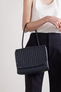 Bottega Veneta's 'Patti' bag is woven from leather in the brand's signature  intrecciato  pattern – each strip is lightly padded for volume. Shown on the Fall '22 runway, it has a compact foldover silhouette free from hardware or emblems. The graceful top handle is long enough to slip comfortably on your shoulder. Luxury Square Woven Leather Shoulder Bag, Luxury Rectangular Shoulder Bag In Woven Leather, Luxury Woven Leather Square Shoulder Bag, Luxury Rectangular Shoulder Bag With Woven Leather, Luxury Woven Leather Rectangular Shoulder Bag, Luxury Rectangular Woven Leather Shoulder Bag, Luxury Square Woven Leather Bag, Designer Woven Leather Shoulder Bag For Formal Occasions, Luxury Woven Leather Office Bags